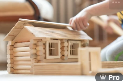 a kid putting together a toy house