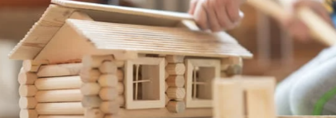 a kid putting together a toy house